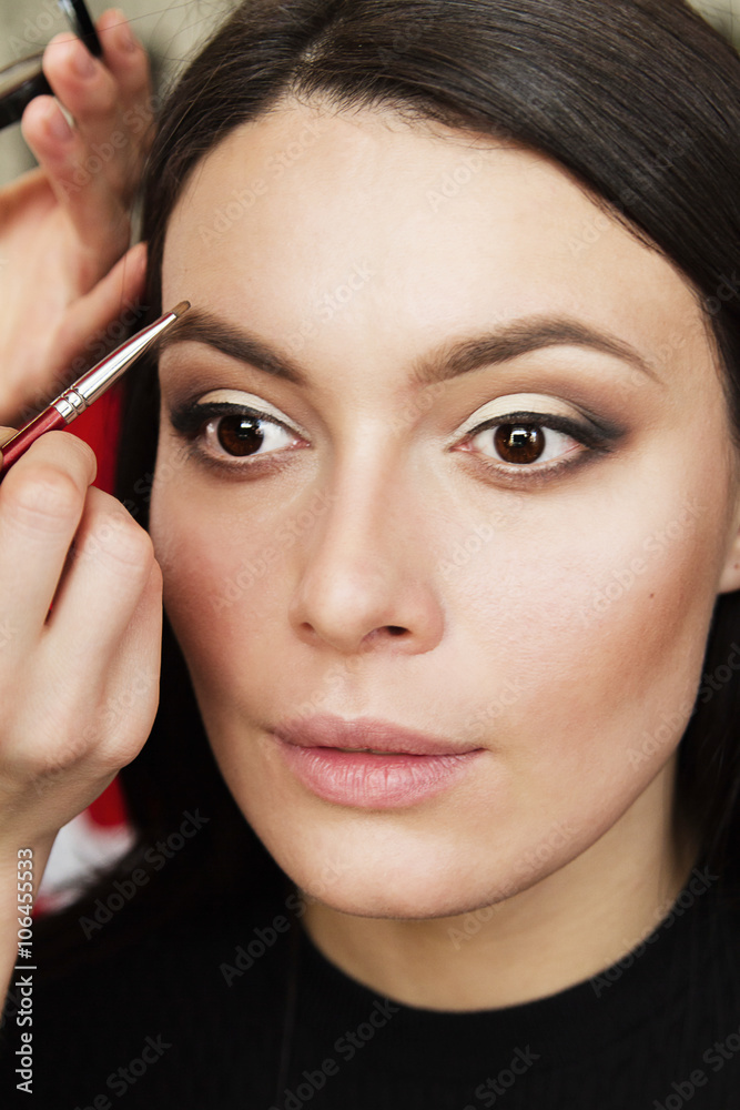 beautiful young woman doing her makeup, eyebrow coloring beautiful young woman doing her makeup, eyebrow coloring