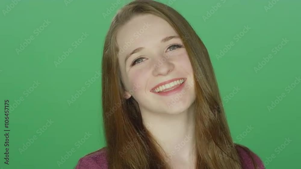 Cute redhead smiling, on a green screen studio background Cute redhead smiling, on a green screen studio background