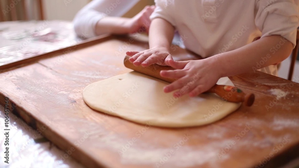 Making cookies with a kid / A mother making cookies with her little girl. Close up on the hands in 1080P.

