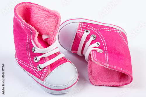 Pair of baby shoes on white background, expecting for baby