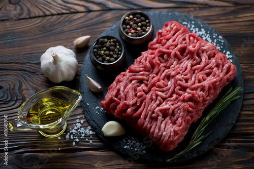 Raw beef mincemeat with seasonings, studio shot, high angle view