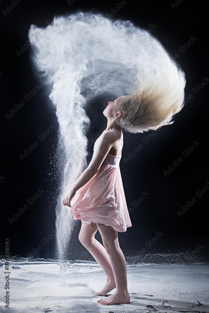 Naklejka premium Portrait of dancer flipping hair with white powder