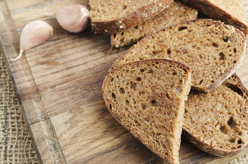 Toasted rye bread on a wooden board. Rustic style. Toasted rye bread on a wooden board. Rustic style.