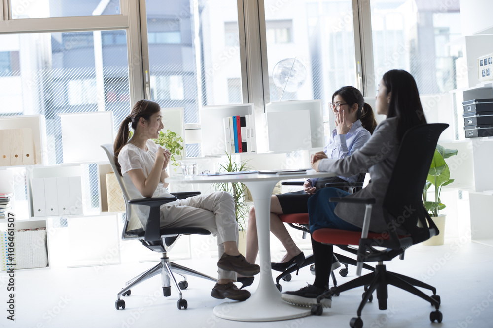 Three business women have a planning meeting at the office