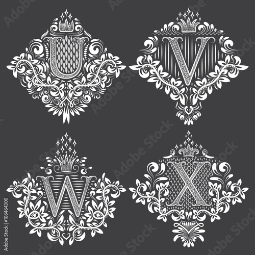 Set of heraldic monograms in coats of arms form. White floral decorative stamps on black. Isolated tattoo labels in vintage baroque style.