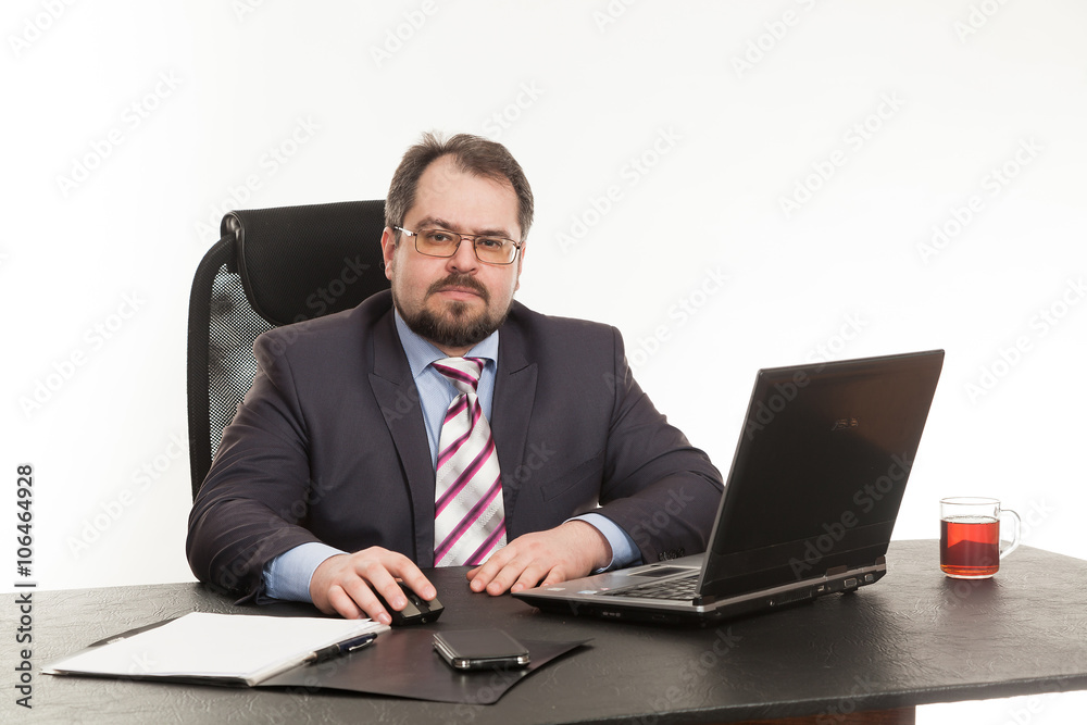 the businessman sits at office table the businessman sits at office table