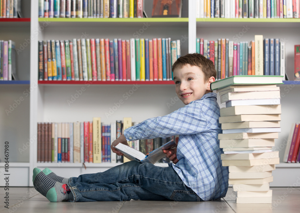 Cute boy reading book in library
Cute boy reading book in library