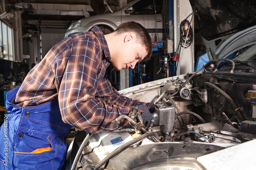 Car mechanic working in auto repair service