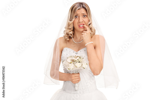 Nervous young bride biting her nails photo