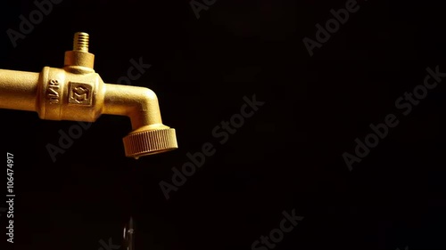 A dripping faucet on a black background
