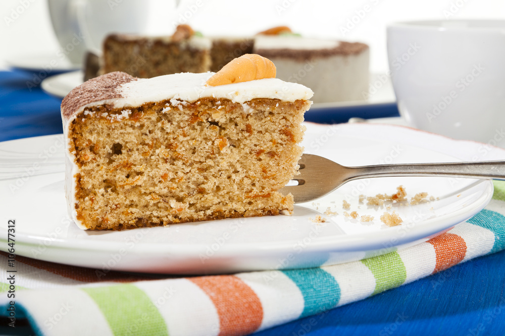 Piece of carrot cake on coffee table Piece of carrot cake on coffee table