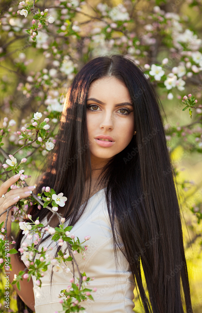 Fototapeta premium Beautiful brunette young woman in park