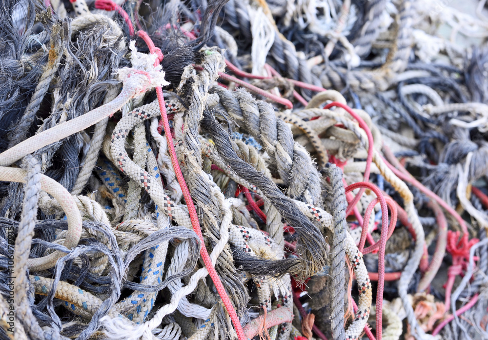 Tangled, old ropes. Stack of old, weathered ropes with selective focus. Close-up of nautical vessel. Chaos scene.