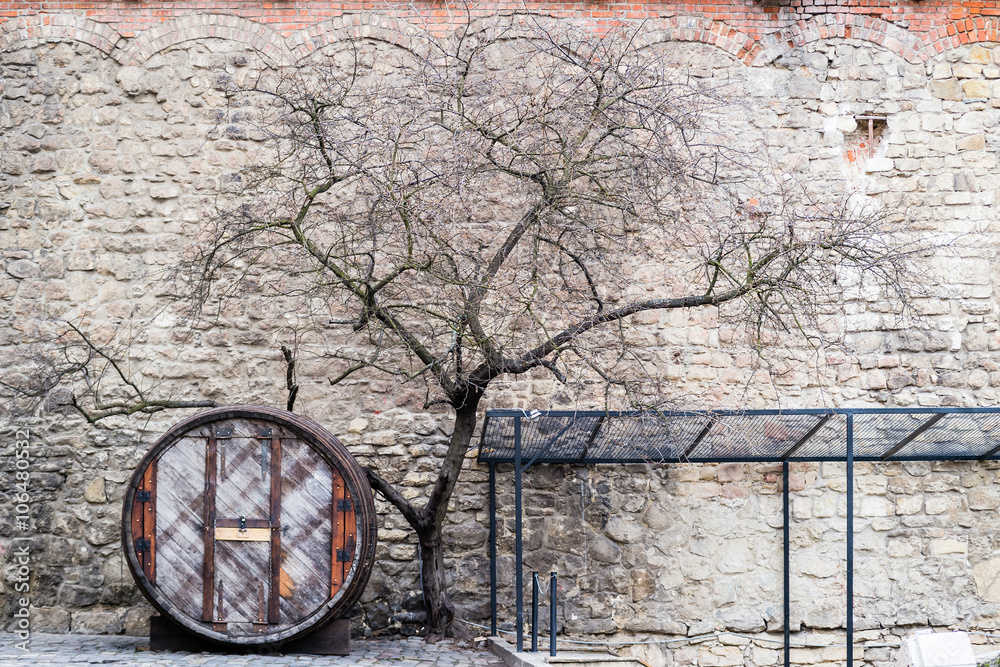 Old oak barrel on the stone wall backgroung Old oak barrel on the stone wall backgroung