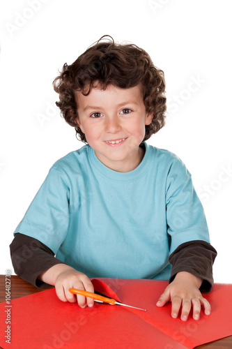 Child doing crafts with cardboard and scissors