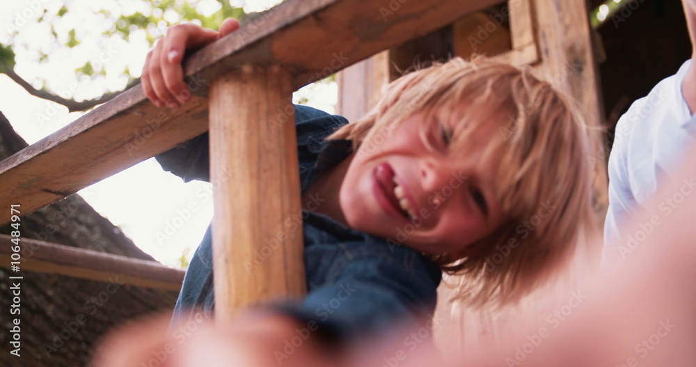 Children pointing fingers at camera while in a treehouse Children pointing fingers at camera while in a treehouse