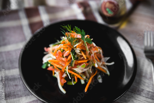 Vitamin fresh vegetable salad julienne on a black plate
