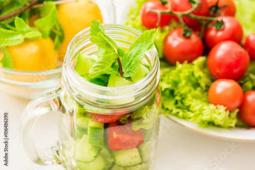 Fresh mixed vegetables salad in glass jar. 