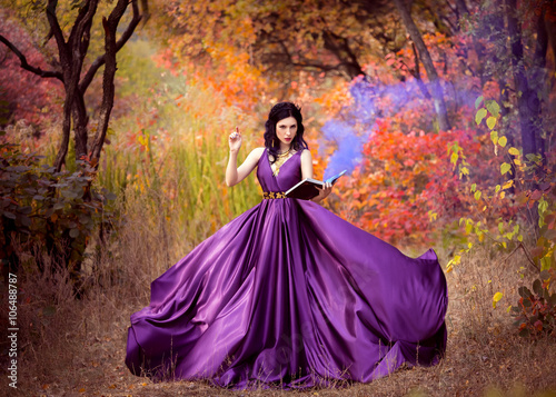 Lady in a luxury lush purple dress swirls in the smoke,fantastic shot,fairytale princess is walking in the autumn forest,fashionable toning,creative computer colors
