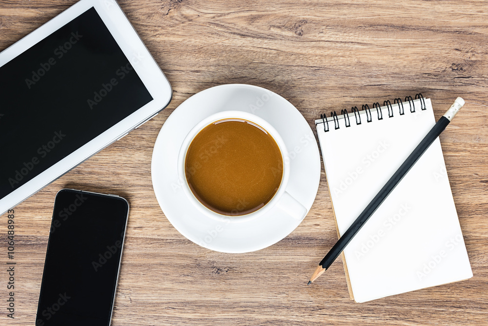 View from above of coffee cup with black smartphone, digital tab View from above of coffee cup with black smartphone, digital tab
