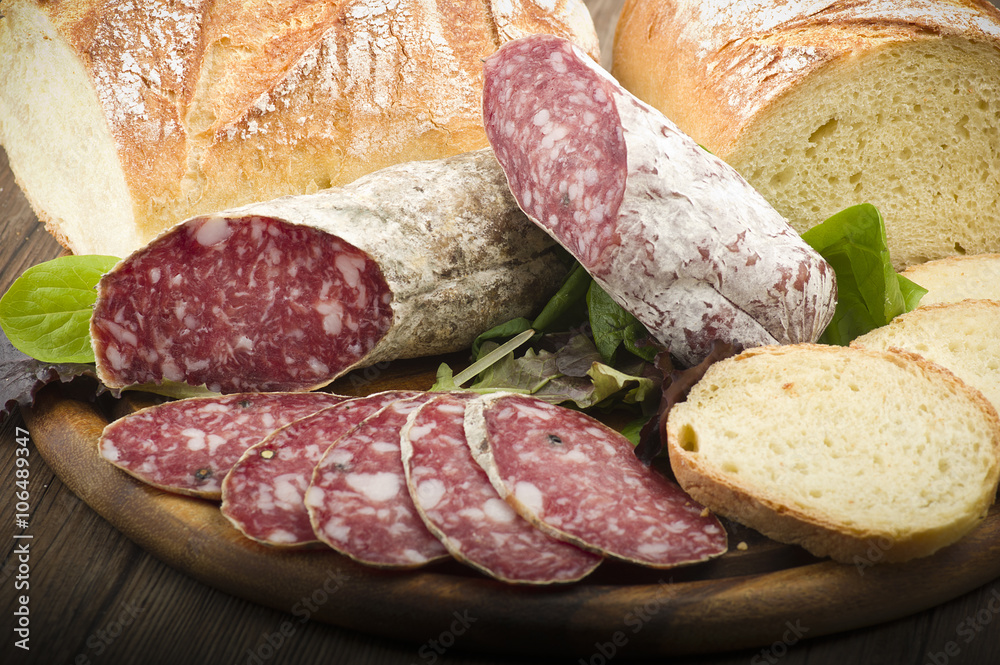 wooden cutting board with salami and bread wooden cutting board with salami and bread