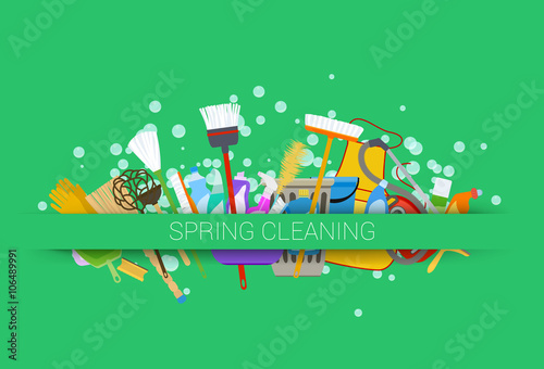 spring cleaning supplies green background. tools of housecleaning
