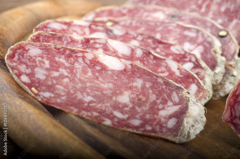 wooden cutting board with salami and bread wooden cutting board with salami and bread