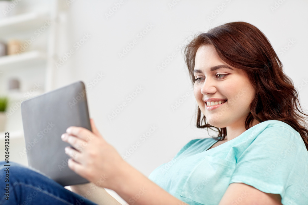 happy young plus size woman with tablet pc at home happy young plus size woman with tablet pc at home