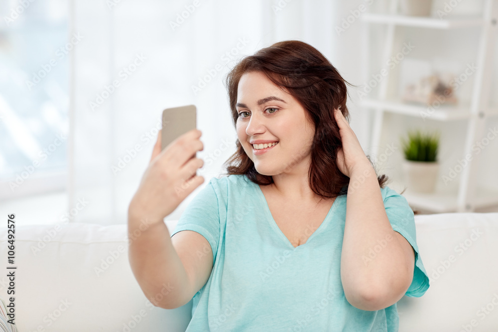 happy plus size woman with smartphone at home happy plus size woman with smartphone at home