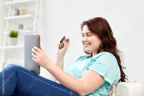 plus size woman with tablet pc and credit card