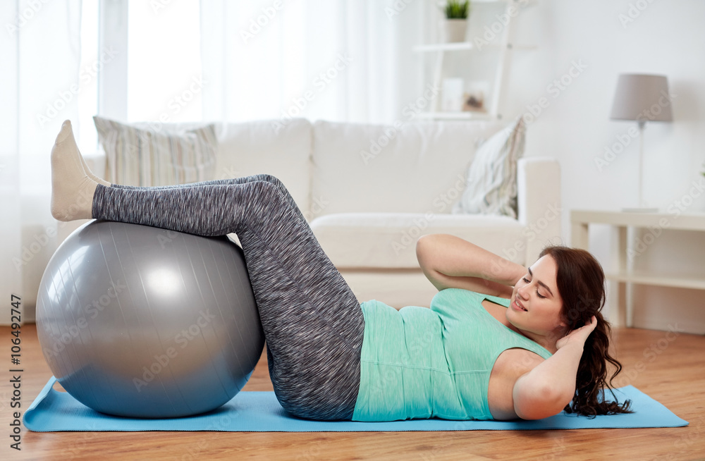 plus size woman exercising with fitness ball plus size woman exercising with fitness ball
