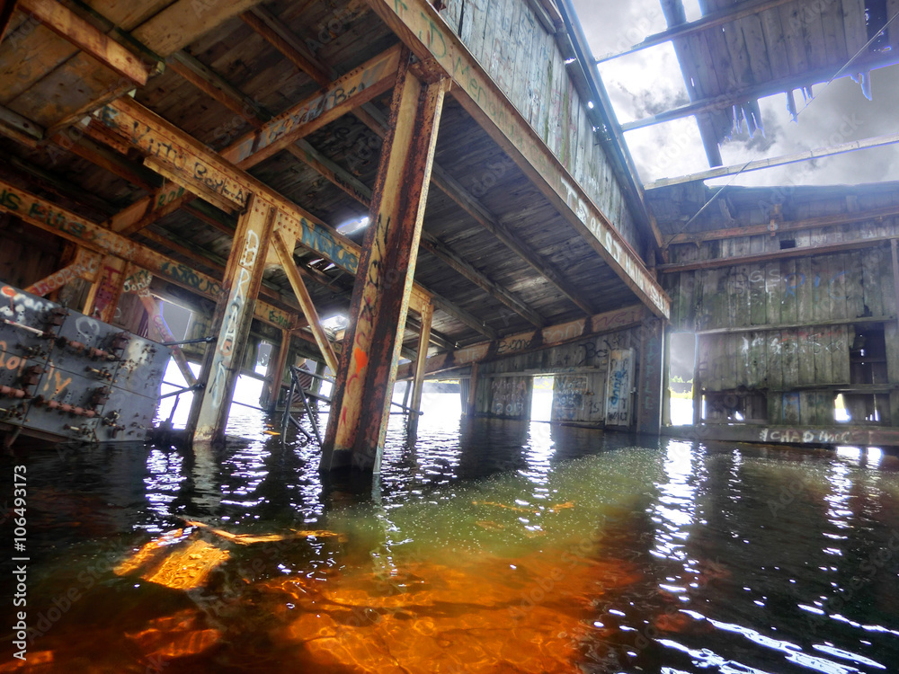 Old rusty industrial beached boat interior - landscape color photo
