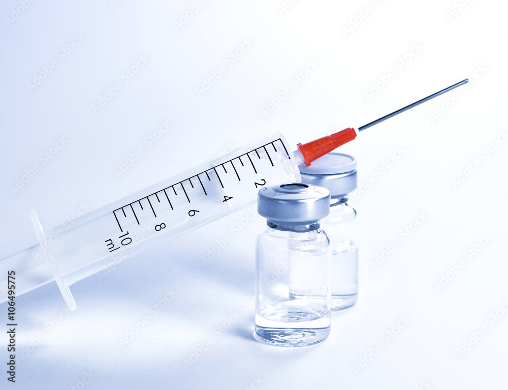 Syringe and vials, isolated with copy space