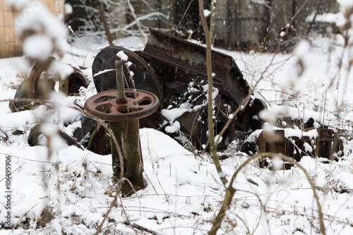 UKRAINE. Chernobyl Exclusion Zone. - 2016.03.20. Old metal parts at the abandonet soviet military base photo