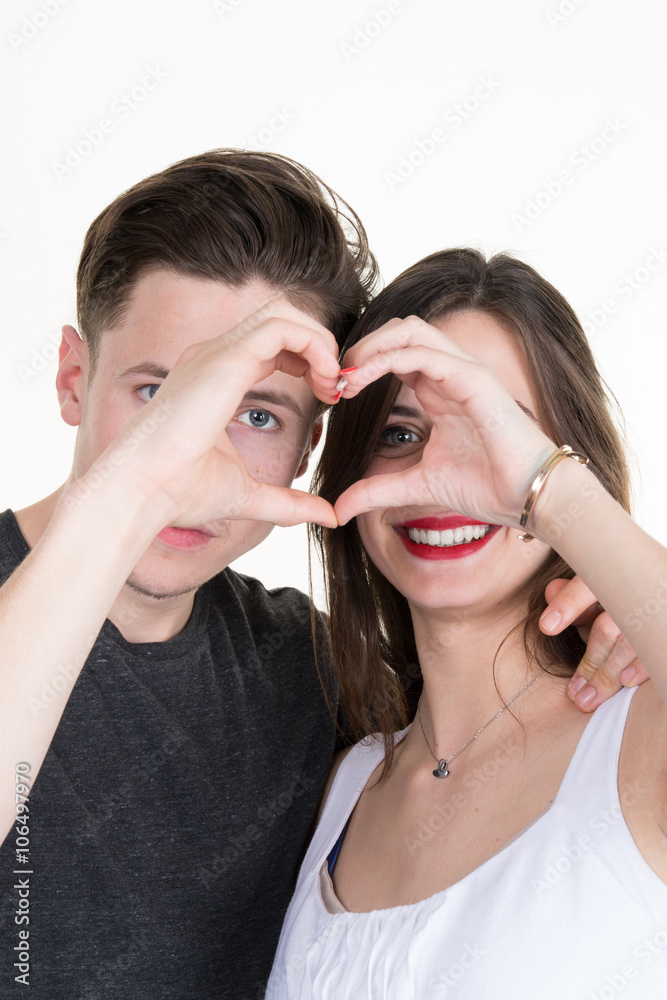 Happy couple in love showing heart with their fingers Happy couple in love showing heart with their fingers