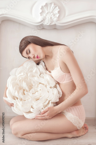 Fotografie Pretty girl in pink underwear with large paper flower
