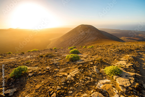 Fototapeta Naklejka Na Ścianę i Meble -  Volcanic landscape view from the top of Caldera Blanca volcano on the sunset on Lanzarote island in Spain