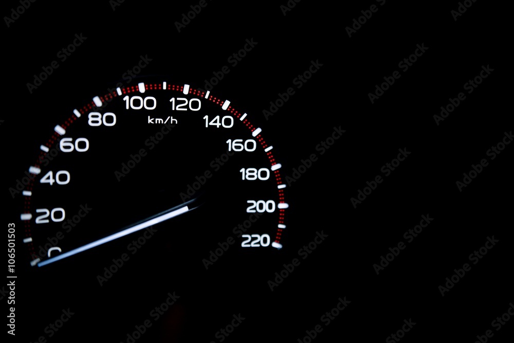 driver's cockpit ; speedometer on dashboard - white light in black, copy space for your design

