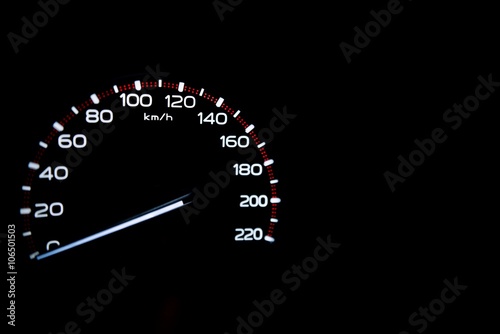 driver's cockpit ; speedometer on dashboard - white light in black, copy space for your design 