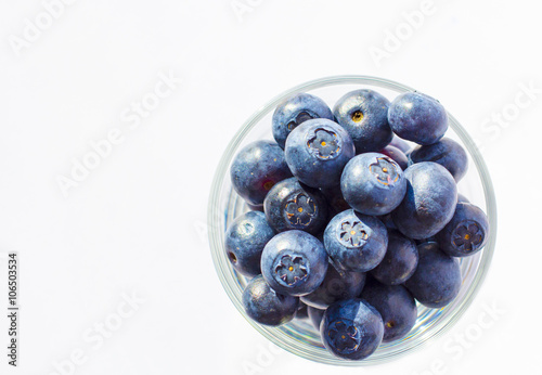 Fresh blueberries in glass background 
