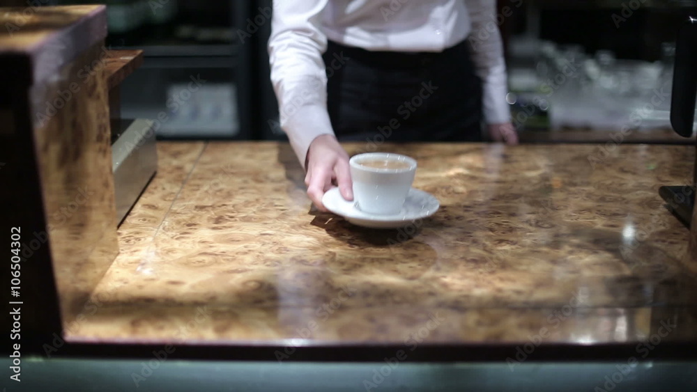 Barista puts a cup of coffee at the rack. Slider camera left to right Barista puts a cup of coffee at the rack. Slider camera left to right