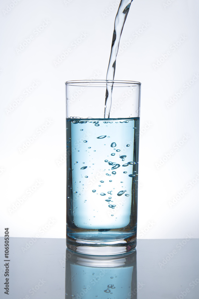 Concept of drinking. Pouring water from into glass Concept of drinking. Pouring water from into glass
