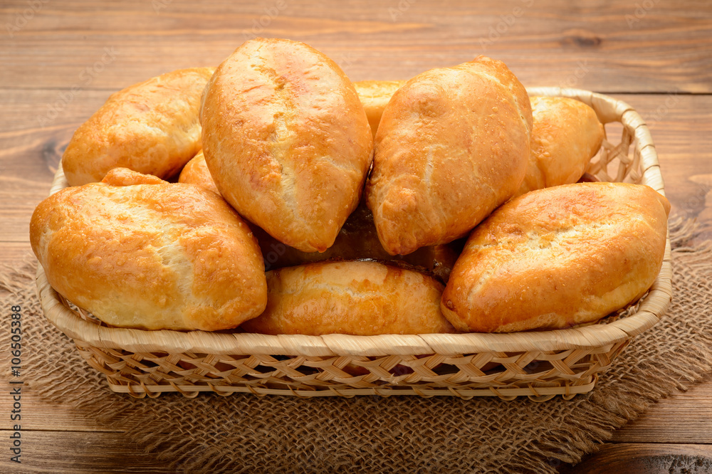 Traditional russian pastry - piroshki on wooden table. Traditional russian pastry - piroshki on wooden table.