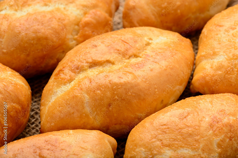 Traditional  russian pastry piroshki as background.