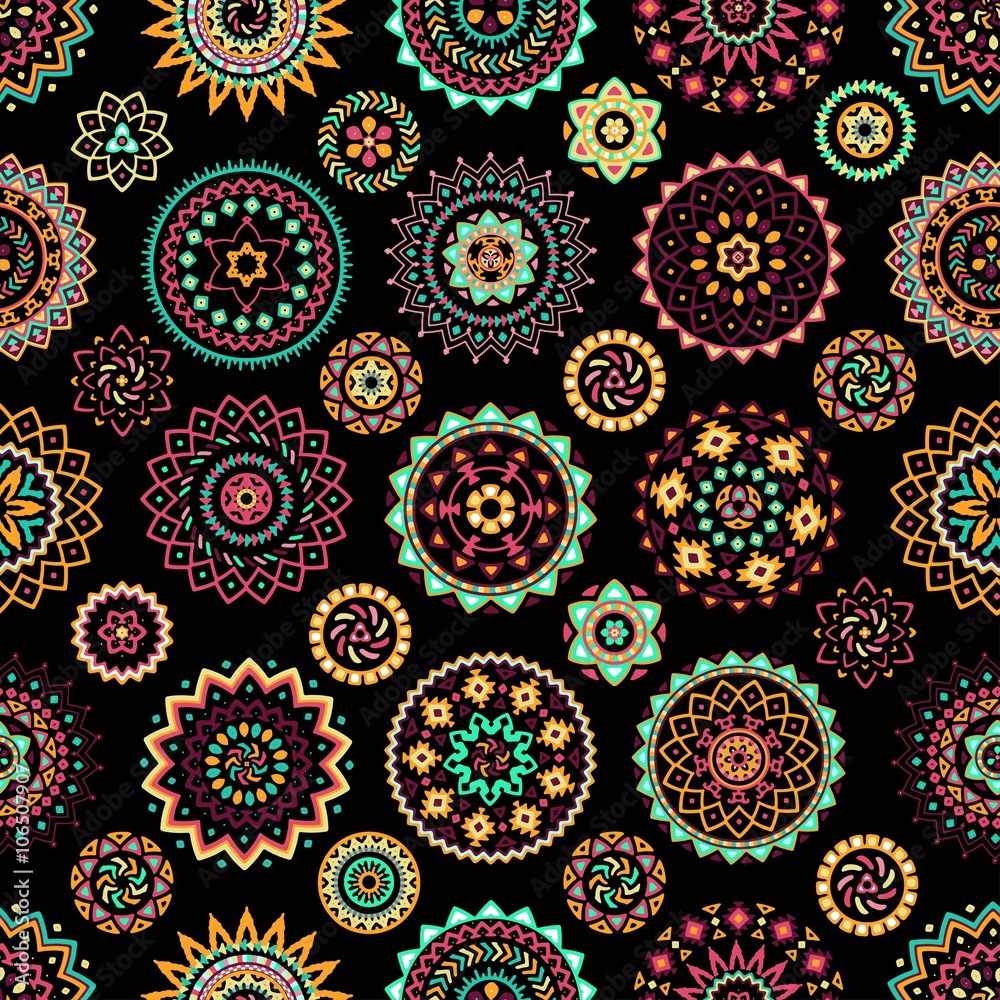 Seamless pattern of bright colorful geometric round ethnic decorative elements. Vector mandala background with bohemian, Oriental, Indian, Arabic, Aztec motifs.