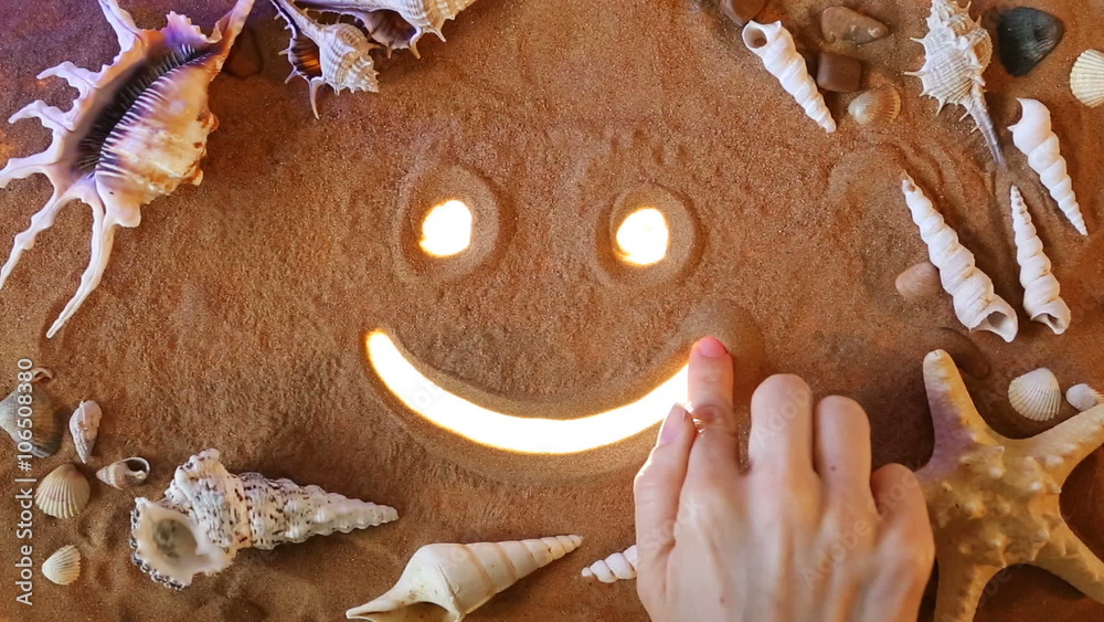 Hand drawing Smile Symbol in the Sand. Beach background. Top view ...
