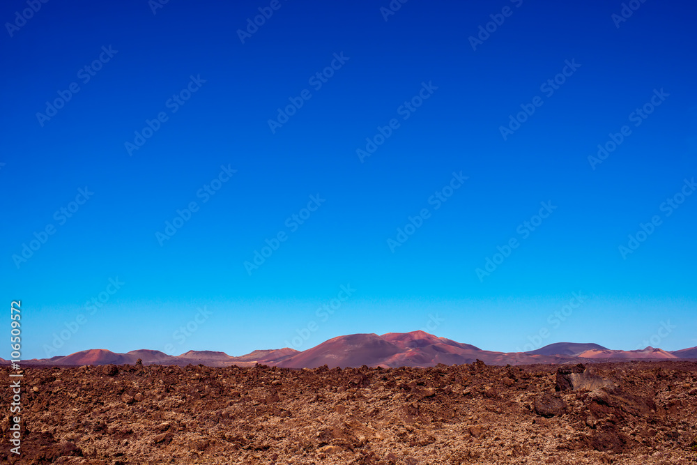 Volcanic landscape on Lanzarote island in Spain. Wide angle view with copy space