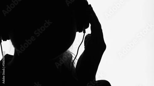 young woman  in headphones listening to music