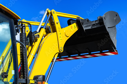 Yellow tractor-loader closeup