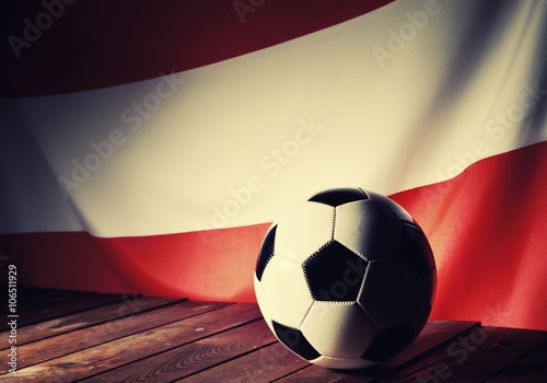 Flag of Austria with football on wooden boards as the background. Vintage Style.